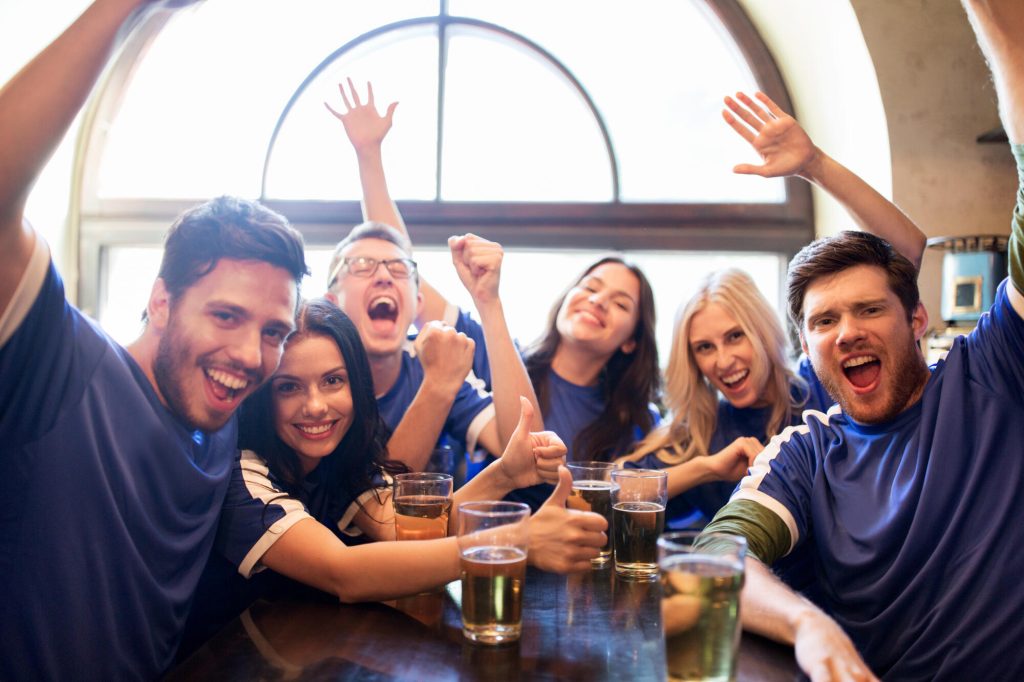 friends sat round a table in a sports bar in oakville